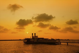 Paddle steamer Tiki III at the jetty at sunset, Les Saintes-Maries-de-la-Mer, Camargue, Provence,