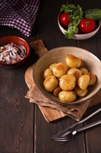 Fresh Cooked, new potatoes, with dill, on a wooden table, selective focus. close-up, toning, no