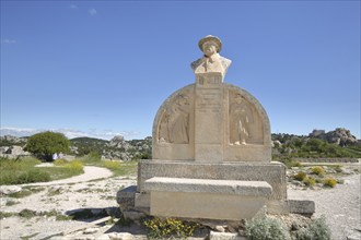 Monument to French writer Charloun Rieu, stone, inscription, bust, relief, plateau, mountain