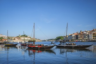 View of Porto city and Douro river with traditional boats with port wine barrels from famous