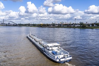 Skyline of Düsseldorf, cargo ship, tanker Enjoy, office tower blocks, residential buildings in