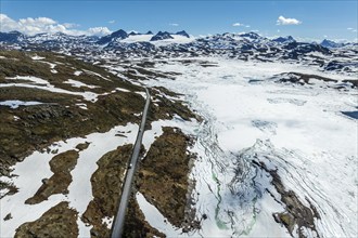 Aerial view of mountain crossing Sognefjellsvegen, along frozen lake Prestesteinsvatnet, view