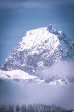 Prominent snowy mountain peak against a clear blue sky, Kaisergebierge, The Mountain Doctor, Elmau,