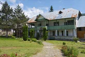 Two-storey monastery building in greenery with trees and a relaxing ambience, House of the Pilgrim,