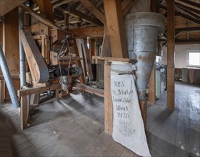 Historic plansifter in a former corn mill, old flour sack from 1936 on the right, Bavaria, Germany,