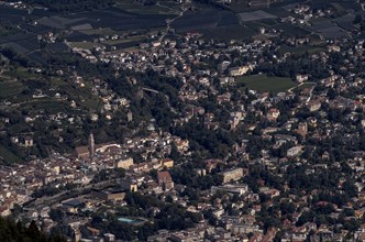 Aerial view of Merano, old town centre with St. Nicholas parish church, thermal baths, Hotel Therme