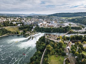 Aerial view of the Rhine Falls with Laufen Castle with autumnal vegetation, on the horizon the town