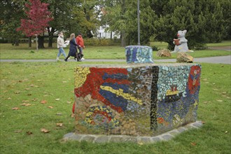 Pedestrian in the park with mouse figure reading a book, bookworm, literature, sculpture, public