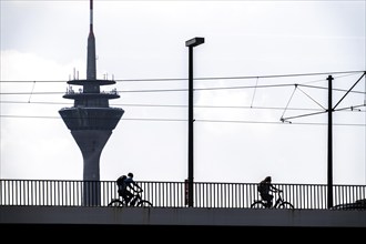 Oberkassler Bridge over the Rhine near Düsseldorf, Rhine Tower, cyclist, North Rhine-Westphalia,