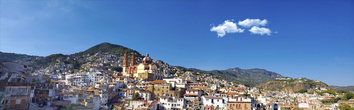 Mexico, Scenic panoramic view of Taxco historic center with colonial houses on the hills and famous