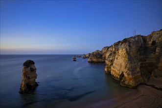 Coloured cliffs and rocks in front of sunrise on the beach, Praia da Dona Ana, Lagos, cliffs,