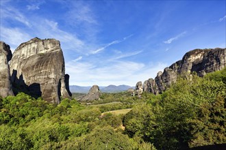 Hermitages between high rocks, monasteries on sandstone formations, Meteora, blue sky, spring