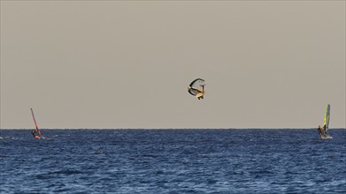 Wingfoiller, A windsurfer performs a jump in the air, Windsurfer, Meltemi windsurfing spot, Devils