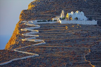 View of Panagia Kimissis church built on a cliff above the sea, Chora, Folegandros Island, Cyclades