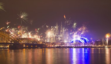 New Year's Eve fireworks, Hohenzollernbruecke with cathedral and Musical Dome, Rheinufer, Cologne,