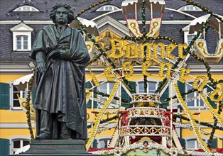 The Beethoven monument in front of the Bonn Christmas market Ferris wheel on Münsterplatz, Bonn,