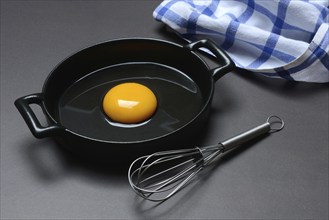 Cracked egg in a pan, hen's egg