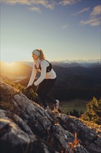 Trail running in autumn on the Jochberg on Lake Walchensee against the wonderful backdrop of the