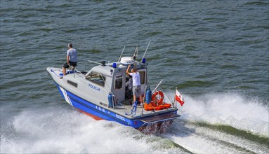 Police boat at full speed on the river Swina in Swinoujscie, Western Pomerania, Poland, Eastern