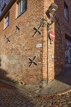 Wall anchor and lantern on a brick building, Kolk street, Hanseatic city of Lübeck,