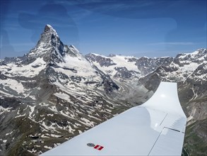 Flight in small aircraft in the swiss alps, view towards peak of Matterhorn, Switzerland, Europe