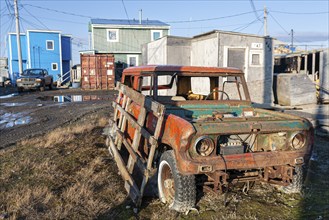 Scrapped car, off-road vehicle in front of simple houses, Arctic, Inuit settlement, Barrow, Alaska,