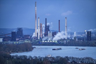 Industrial backdrop of the ThyssenKrupp Steel steelworks in Duisburg-Bruckhausen, cargo ships on