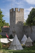 Camp in front of historic city wall with defence defence tower, Medieval Week, Hanseatic City of