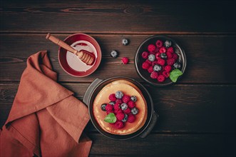 Breakfast, pancakes with berries and honey, top view, homemade, no people, on a wooden background