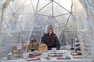 London, Ontario, Canada - A woman sells bracelets and other items in a shelter outside Covent