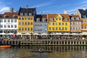 Colourful houses, restaurants and historic ships on the Nyhavn canal and harbour, Copenhagen,