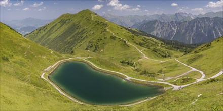 Riezler Alpsee, an artificial lake, snow pond, feeds the snow cannons that completely cover the