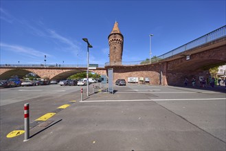 Gatehouse and Main bridge with car park under blue sky with cirrostratus clouds in Miltenberg,