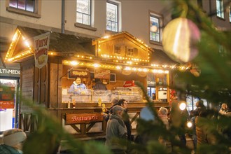 Christmas market with illuminated wooden hut and people in a cosy atmosphere, Lichternacht Fest,