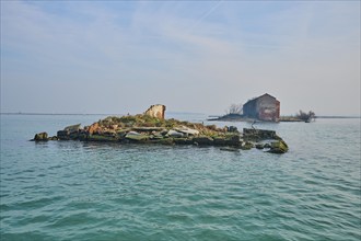 An ancient ruin on a small island on the waterway between Venice and Murano, Italy, Europe