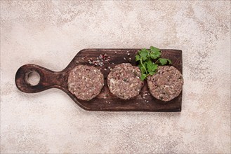 Raw cutlets, minced meat, on a chopping board, homemade, top view, no people