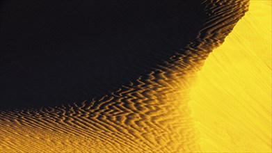 Wind-sculpted sand structure in the Rub al Khali desert, Dhofar province, Arabian Peninsula,