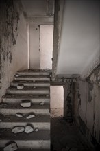 Abandoned destroyed staircase in a residential building, Soviet apartment blocks, ghost town,