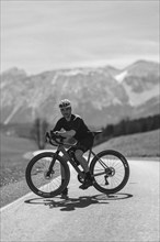 Road bike rider in spring in the Allgäu against the picturesque backdrop of the Alps, Bavaria,