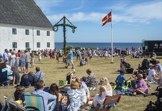 Traditional midsummer celebration with dancing around the maypole at Smygehuk, Smygehamn,