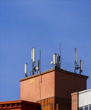 Transmission masts and mobile phone antennas on a rooftop, Berlin, Germany, Europe