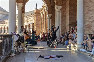 Flamenco dancers and guitarists perform in front of a tense audience under masonry arches, Seville