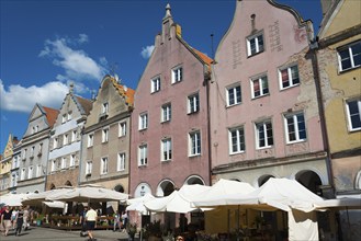 Charming old town with pastel-coloured buildings and sunlit market stalls, Old Town, Olsztyn,