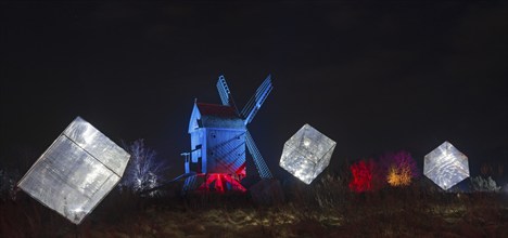 Windmill with illuminated cubes in a darkly lit scene at night, World of Lights, Illumination, Mill