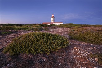 Lighthouse on Cabo Espichel cape Espichel on Atlantic ocean at dusk evening twilight. Sesimbra,