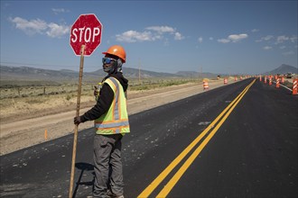 Kremmling, Colorado, A highway worker stops westbound traffic on U.S. Route 40, where construction