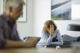 Symbolic photo on the subject of problems in a partnership. An older woman and an older man sitting