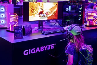 Child in front of a screen with a computer game at the Gigabyte Technology stand, Gamescom trade