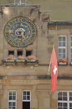 Swiss national flag and astronomical clock, moon clock, town hall, town hall square, Schramberg,