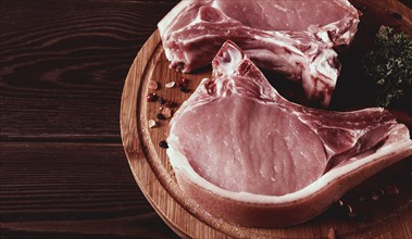 Fresh, raw pork meat, sliced, on a cutting board, with spices, horizontal, rustic style, toning, no